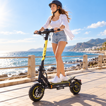 Kvinna med hjälm åker Wheely - H7 på en strandpromenad vid havet en solig dag