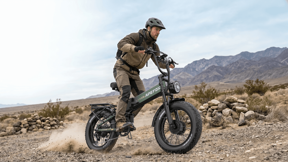 Person som kör APEFOX RH20 hopfällbar fatbike-elcykel på en gräsplan