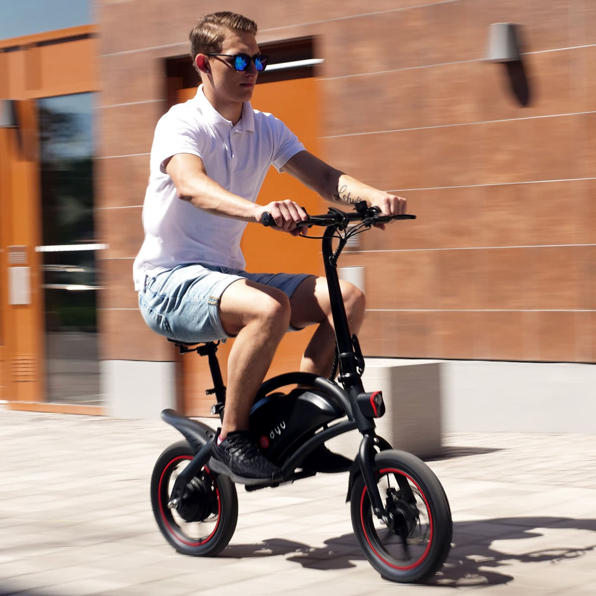 Man som kör DYU D3S hopfällbar elcykel i stadsmiljö