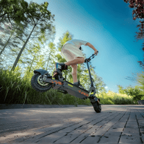 Förare gör ett hopp med KuKirin G2 VMP elsparkcykel på en väg
