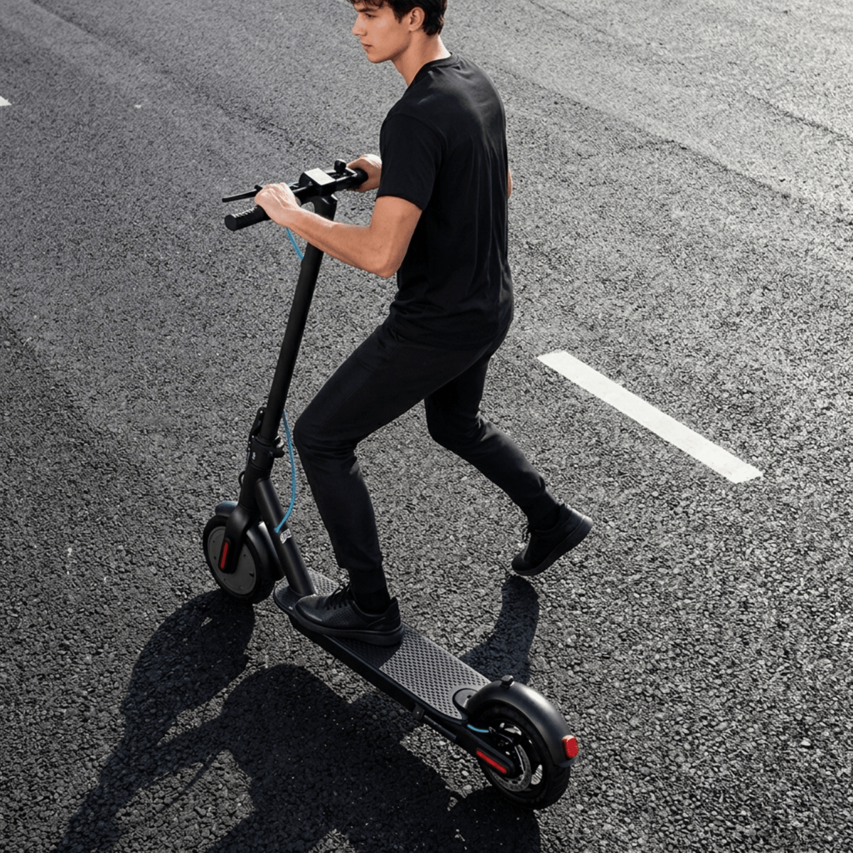 Man som kör SEEDREAM RED WING MINI elsparkcykel på en väg
