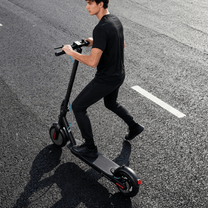 Man som kör SEEDREAM RED WING MINI elsparkcykel på en väg