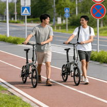 Två förare med YANGOR H19 hopfällbar elcykel i färgen beige på en gångväg